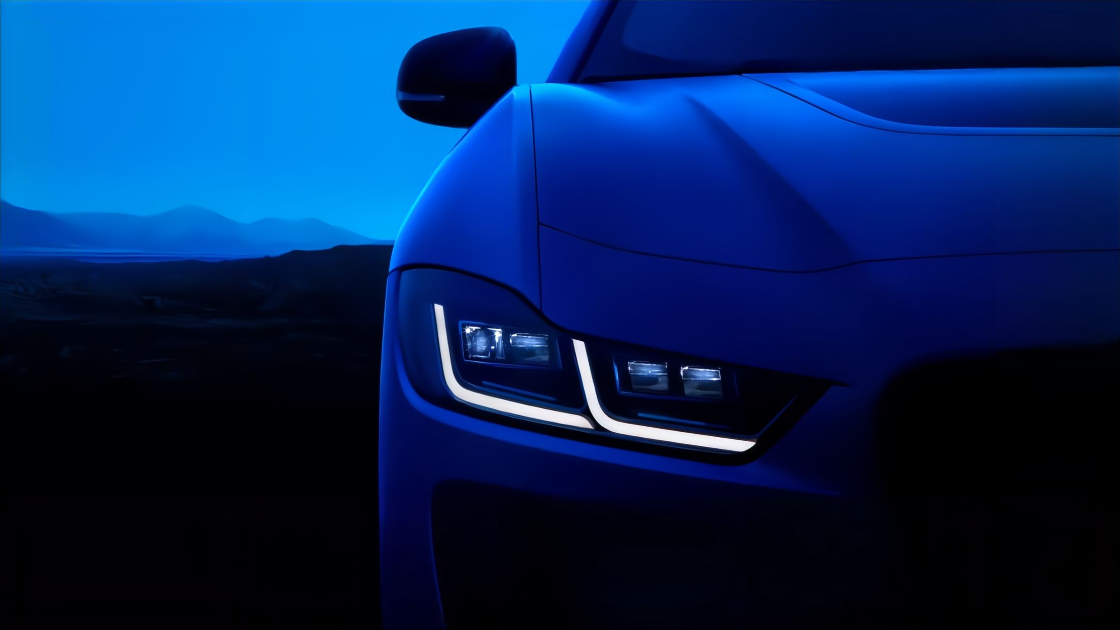 Jaguar car driving on a road